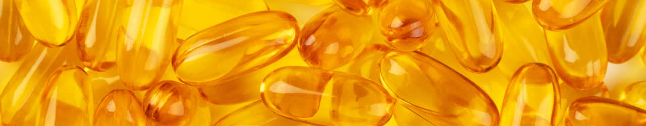 Omega-3s presented in soft gels filled with vibrant golden algal oil.