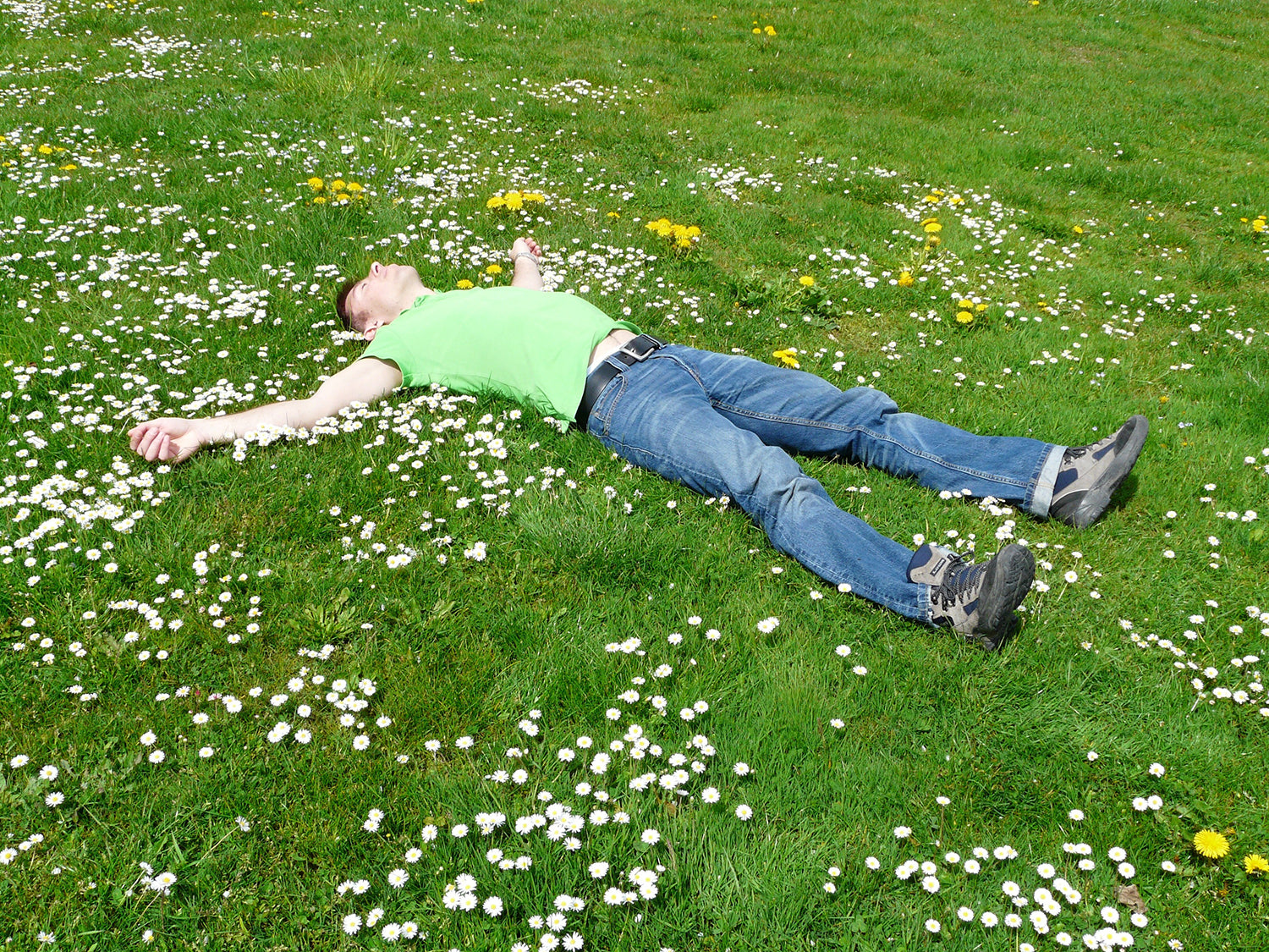 A Man Laying on the Grass Enjoying Sun