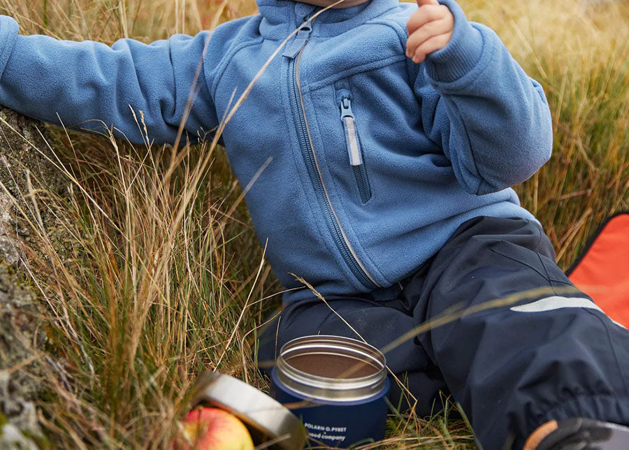 A Kid Eating from Eco-Friendly Lunch Box on a Plastic-Free Picnic