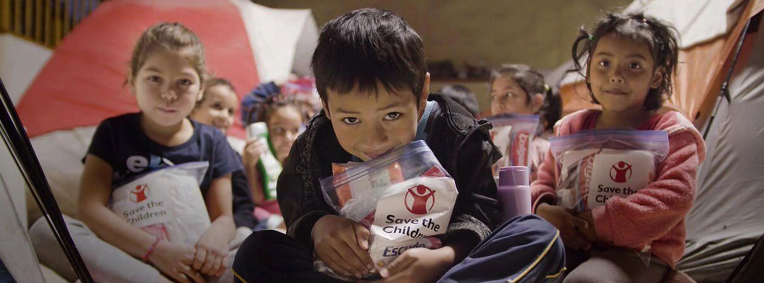 Kids Holding Save the Children Food Kits