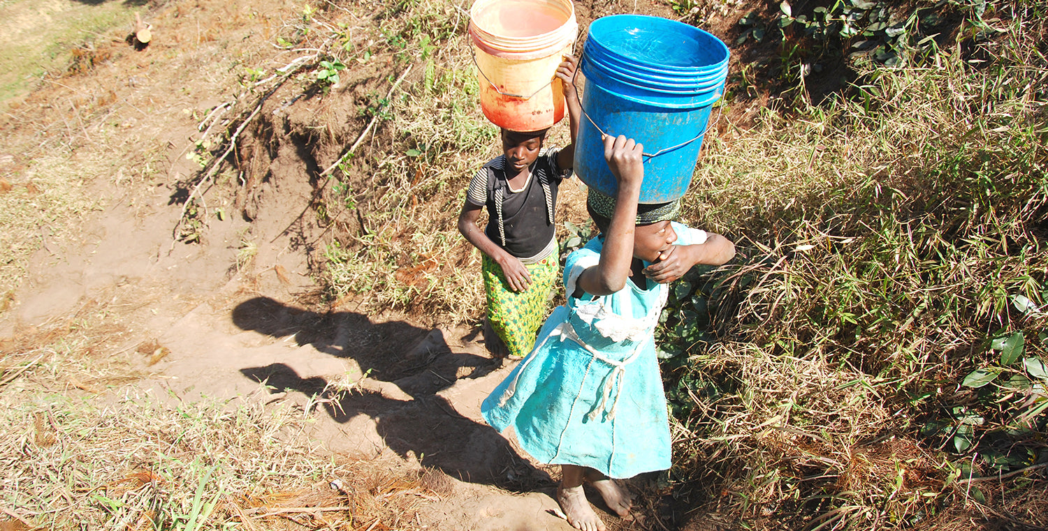 Tanzania Two Girls Carrying Water