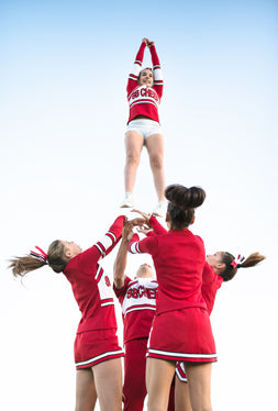 Cheerleaders doing stunts with cheer shoes on