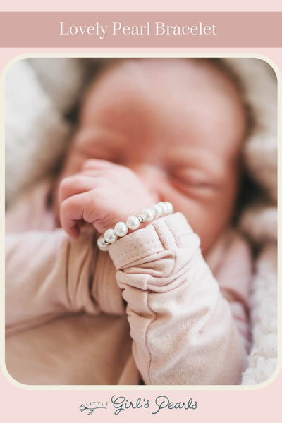 tiny sleeping baby wearing a lovely pearl and silver bracelet gift for girls.