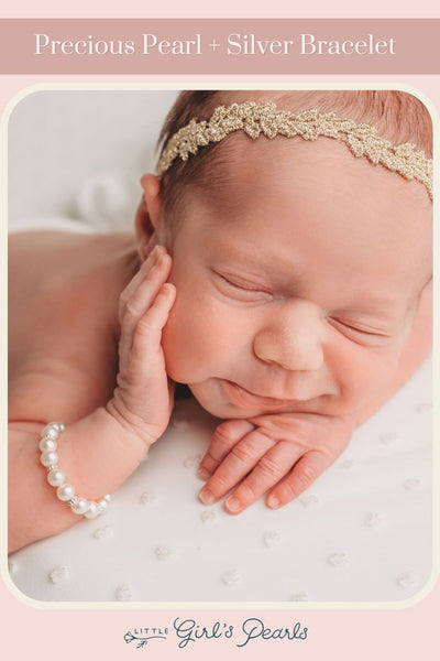 adorable sleeping baby wearing a precious pearl bracelet by little girl's pearls.
