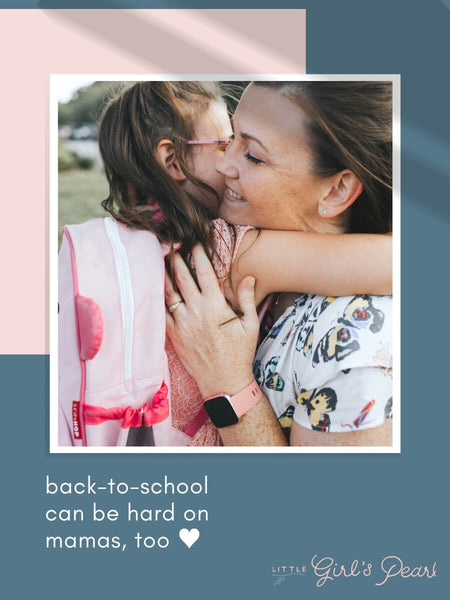 mama and little girl hugging on the first day of school.