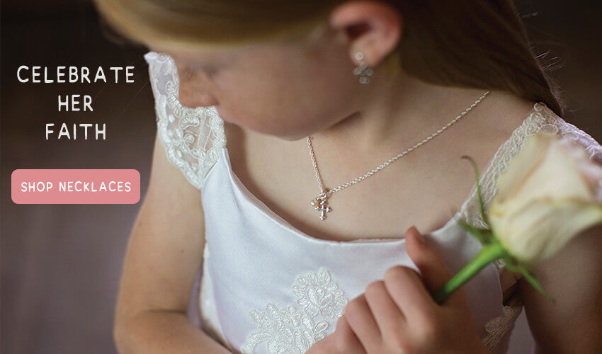 Little Lutheran girl wearing a cross necklace for her first communion.