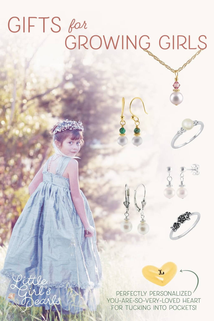 Girl in blue silk dress in a field, showcases beautiful jewelry for girls - a gift guide.