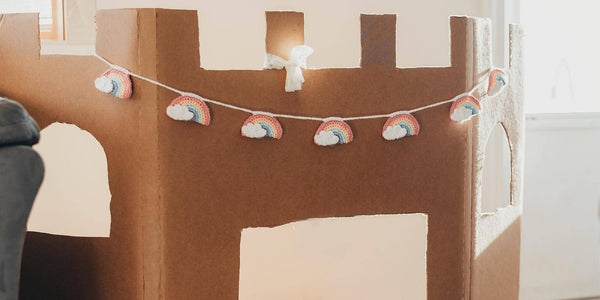 cardboard castle with a rainbow garland.