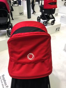 Head-on view of the Bugaboo Fox2 stroller; you can see the mesh peekaboo window in the stroller's red canopy.