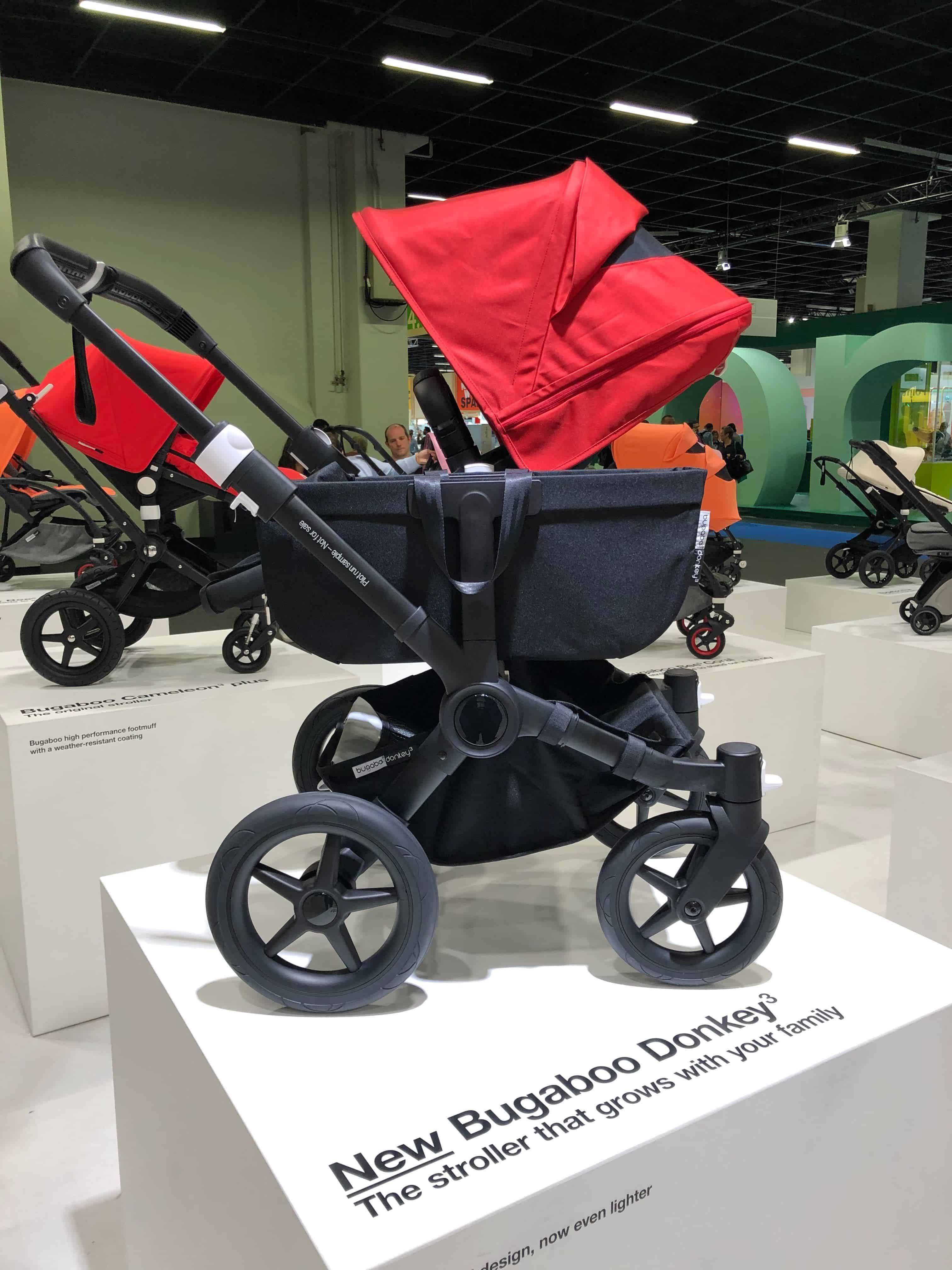 Red and black Bugaboo Donkey3 stroller against showroom background