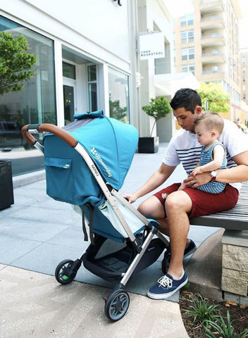 Man and child interacting with Minu stroller