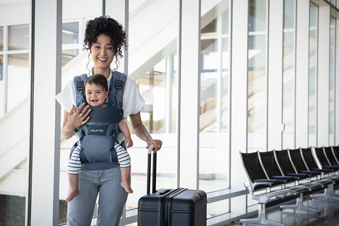 A woman carrying her baby in a NUNA CUDL Carrier 