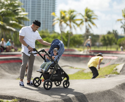 Man interacting with child in Stokke Beat at a skate park