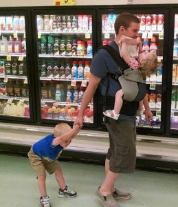 cindy's husband multitasks with toddlers and baby carrier