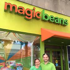 Eli and Sheri standing in front of the Magic Bean Brookline storefront