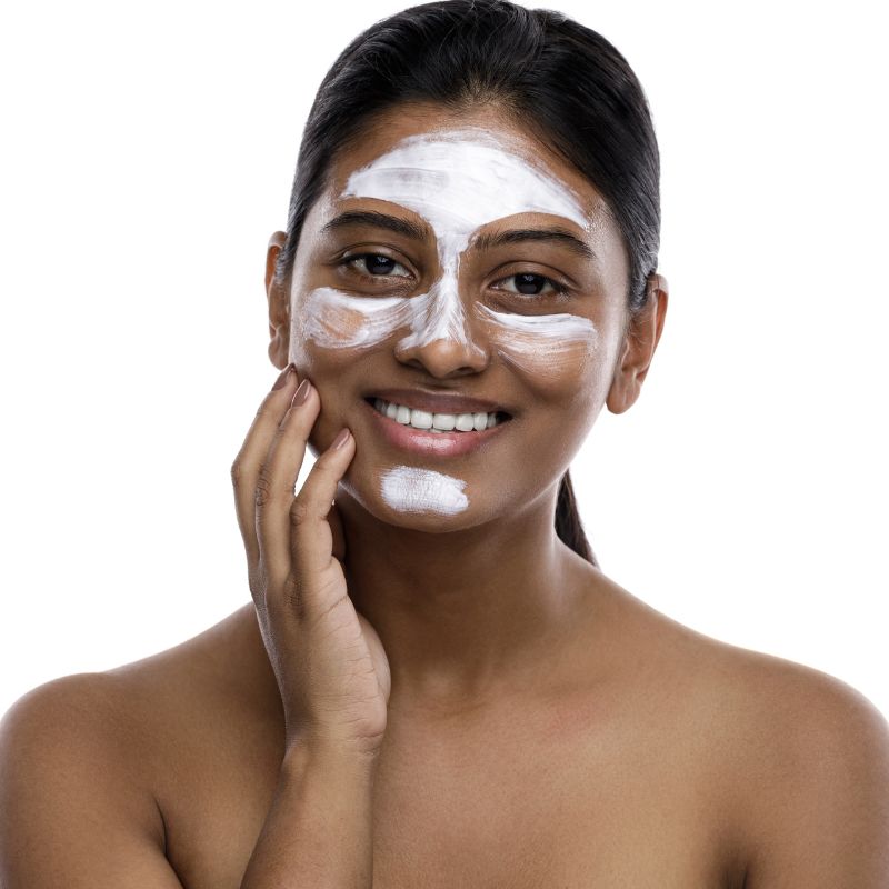 Image of an Indian woman using camel milk skincare