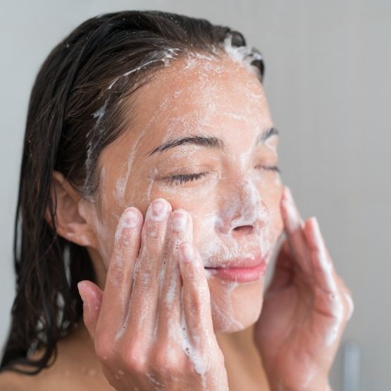 Image of woman cleansing her face with CameLife's Facial Cleansing Bar