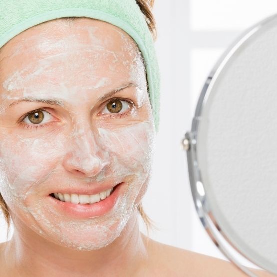 Image of a mature woman exfoliating with CameLife's Refining Facial Polish