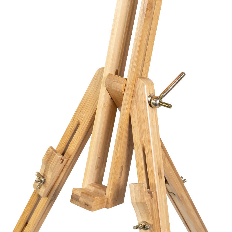 Premium Photo  Wooden easel stands on a stand against the backdrop of a  building and a beautiful green spruce