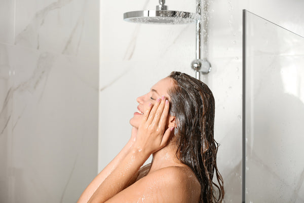 Woman washing her hair with the best shampoo for her in the shower