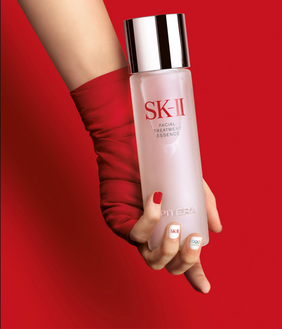 SK-II Facial Treatment Essence Bottle on Red Background