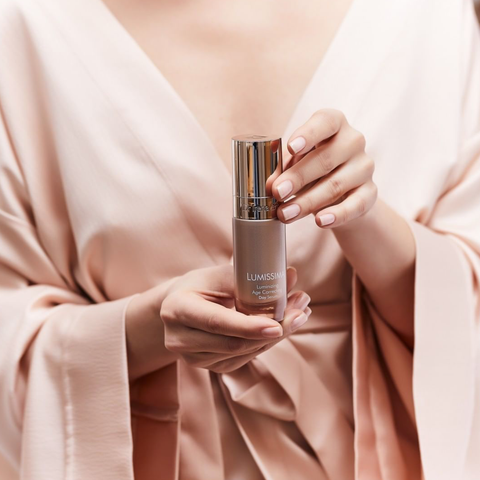 Dr Irena Eris Lumissima product shot held by woman in silk robe