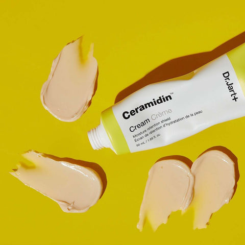 Swatches of Dr Jart Ceramidin Cream on a yellow background
