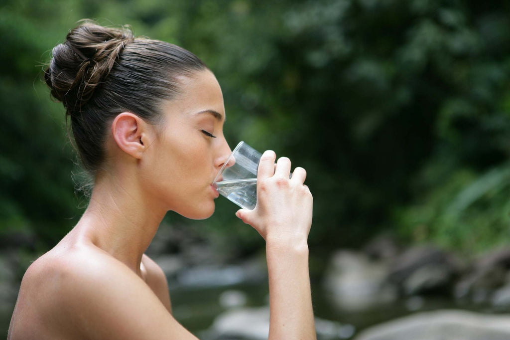 Woman drinking water for healthy skin