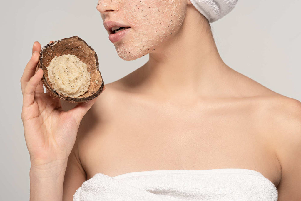 Woman exfoliating skin with natural coconut scrub
