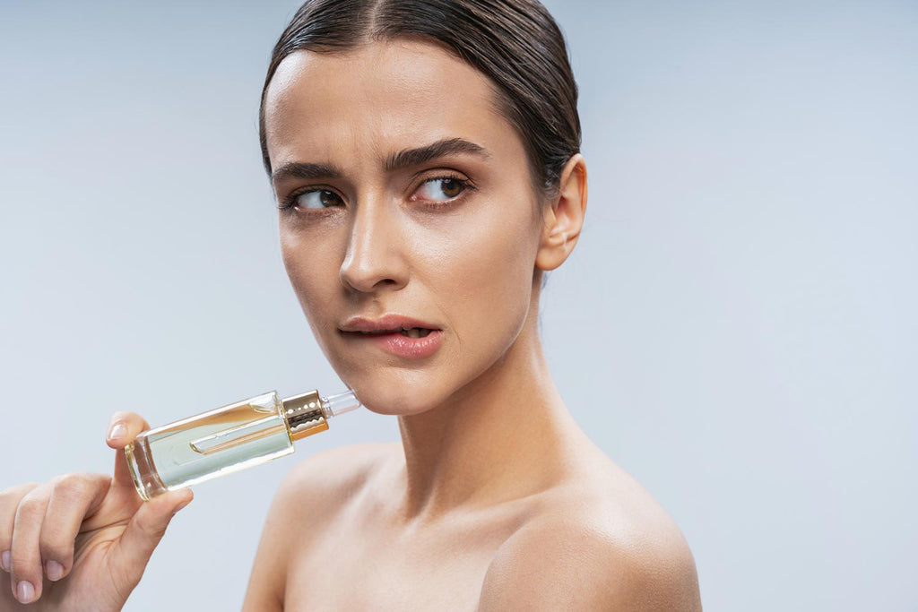 Woman holding skincare serum looking worried