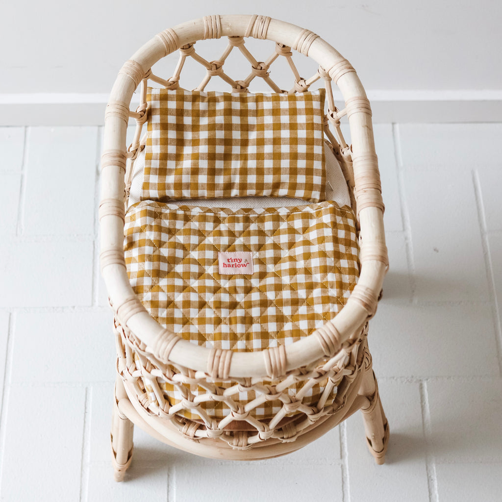 Tiny Harlow Gingham mustard doll's bedding set up in rattan standard doll's bassinet