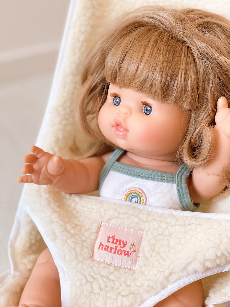 Doll sitting in Tiny Harlow Sherpa stroller