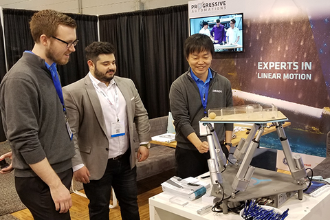 Photo of three men that watching on linear actuators by Progressive Automations 