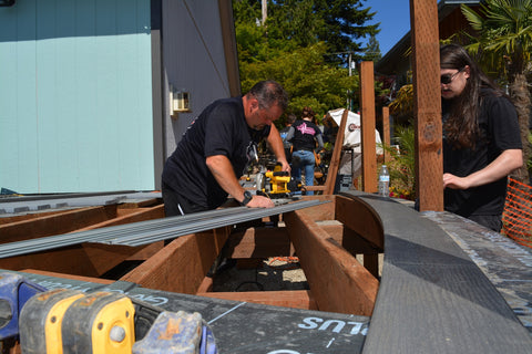 Photo of two-man who working on installing a BBQ 