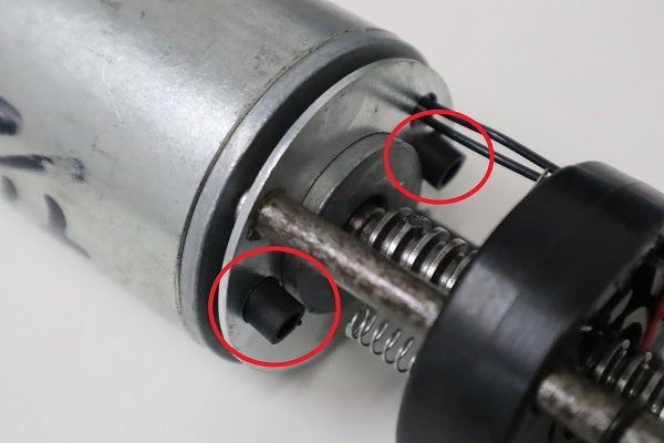 Replace the small plastic spacers into the metal circle and slide the limit switch block into place