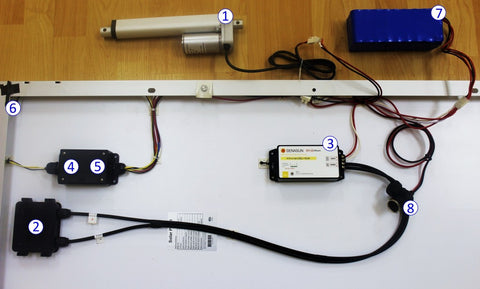 Photo of a mini linear actuator and control system components
