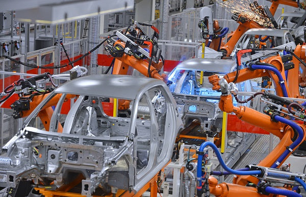 Image of a robotic arms in an automobile factory