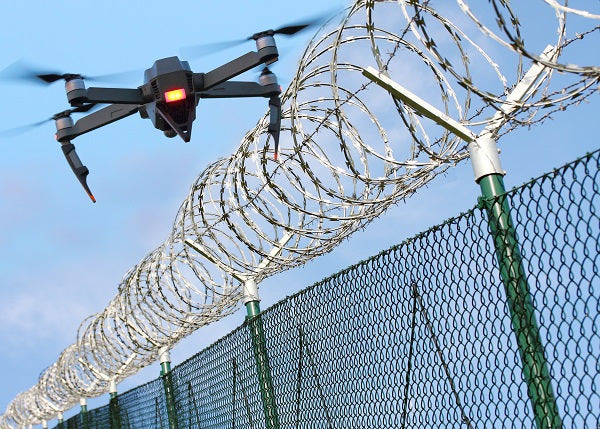 Photo of a drone near a wire fence in a restricted access area