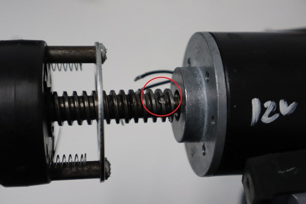 Locate the pin that holds the lead screw with the motor
