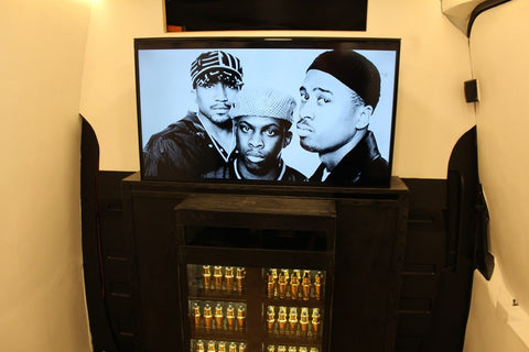 Photo of three men on the TV screen