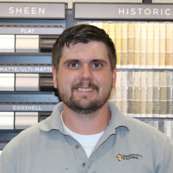 Michael Greening standing in front of Benjamin Moore color samples at Standard Paint & Flooring's Downtown Yakima location.