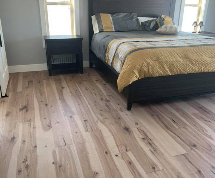 Bedroom floor with Shaw inspiration hardwood in hickory, available at Standard Paint & Flooring