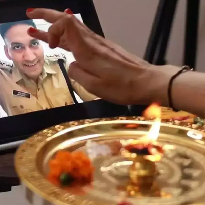 A brother and sister connecting virtually through video call, celebrating Raksha Bandhan together.