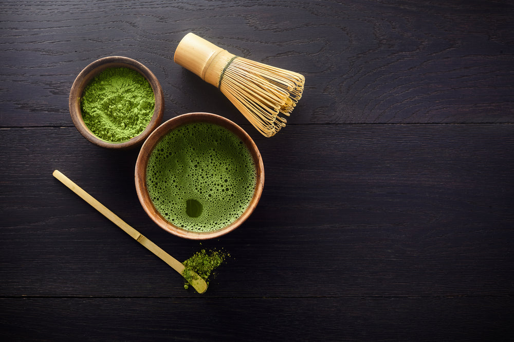 superfood science matcha green tea cup of matcha, powder, and whisk on table ceremonial grade