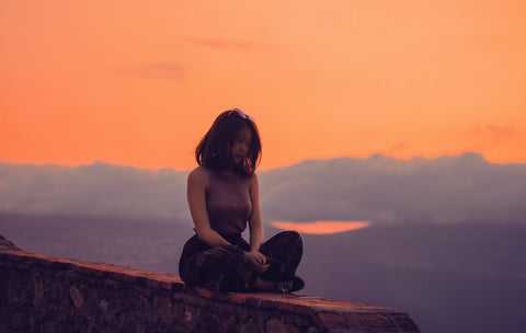 Woman sitting at twilight