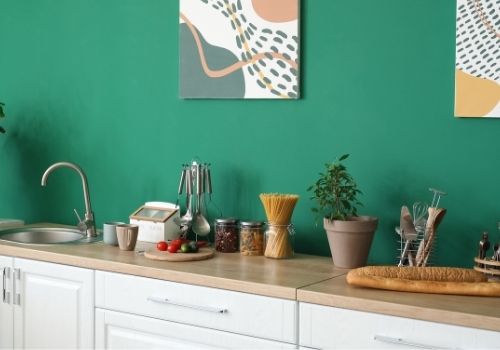 Kitchen area painted with a bright green/blue paint color. 
