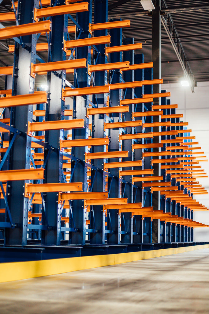 Banks of orange cantilever shelves await heavy loads in a warehouse