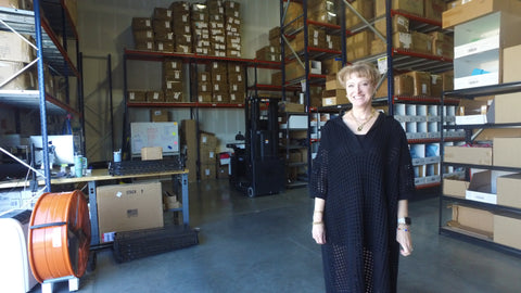Dressed in LaLa's Paula Nelson-Hart standing in the company's new warehouse and fulfillment center.