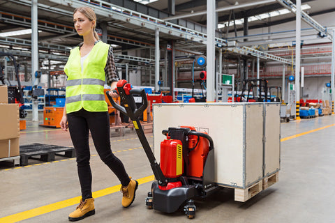 Woman pulls electric pallet jack with full load