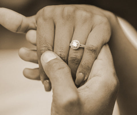 two hands and engagement ring